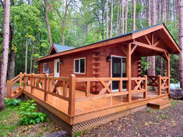 Rustic warm colored log cabin in the woods.