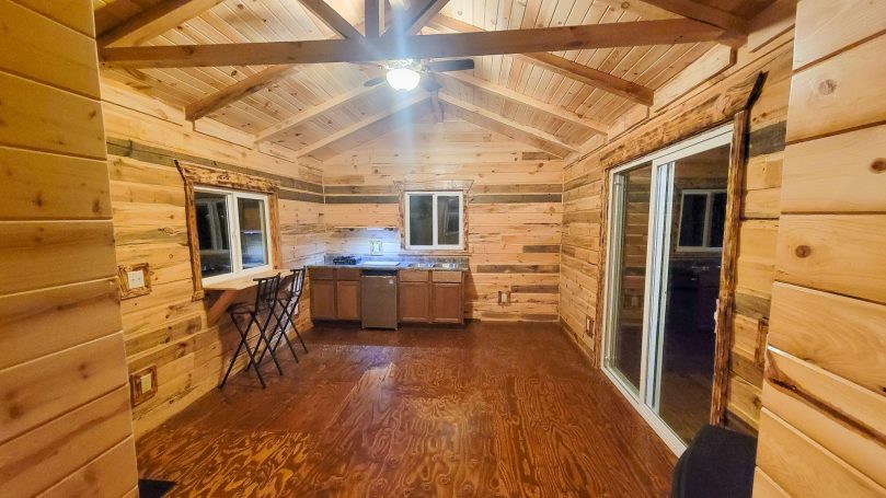 Inside log cabin with kitchen and window table.